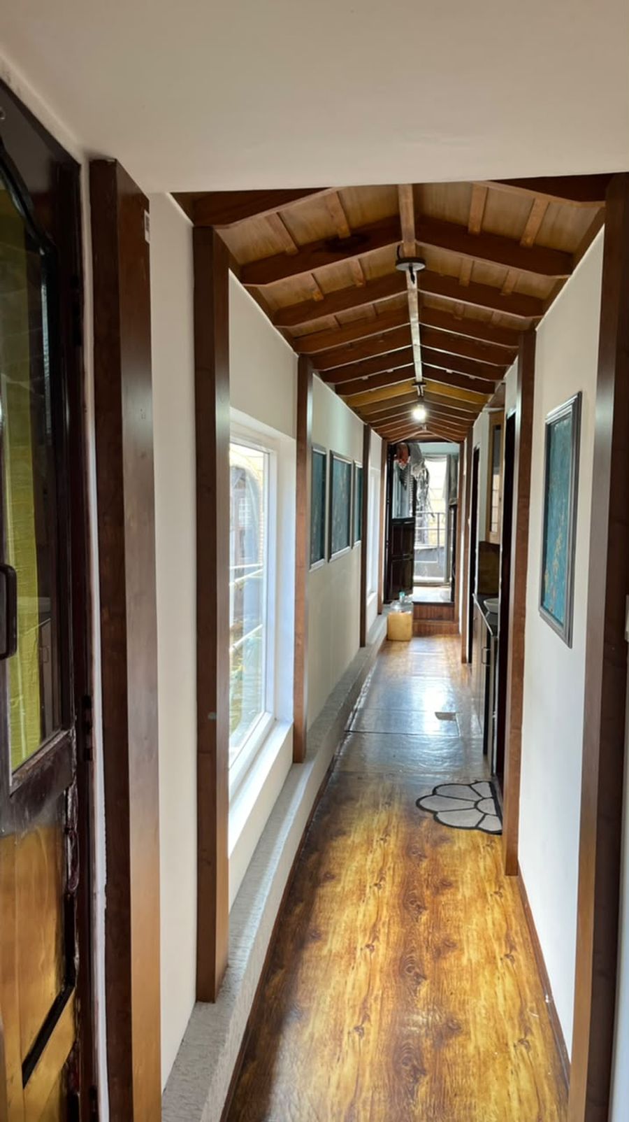 A wood-floored corridor leading to the houseboat cabins