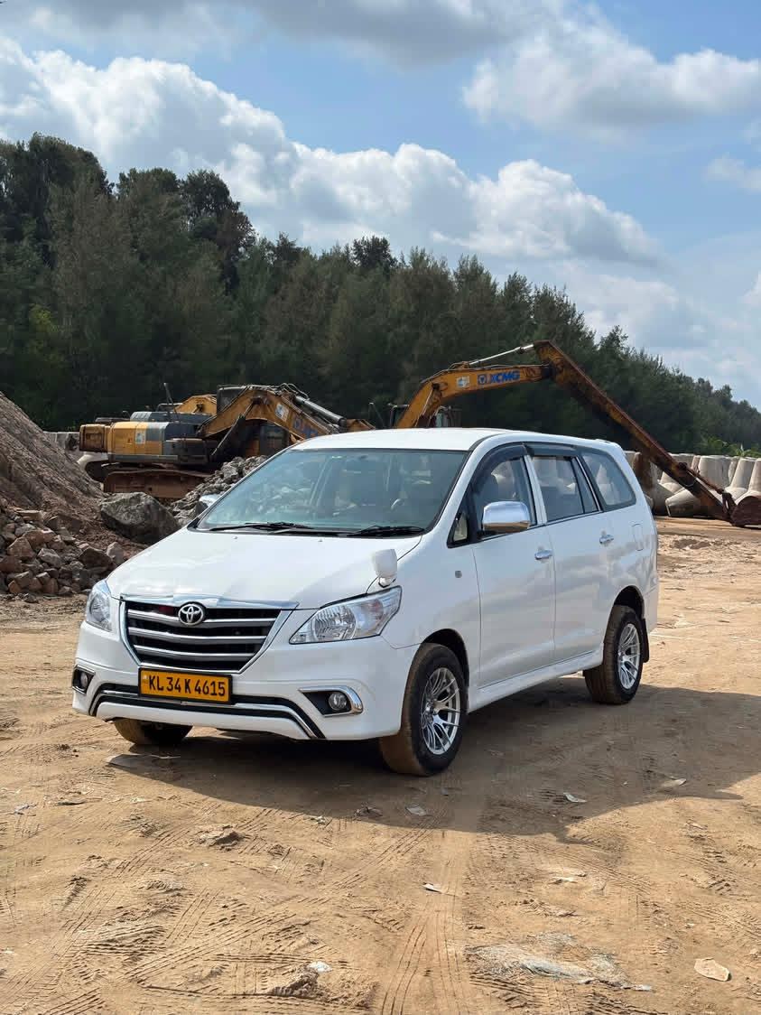 Our white Toyota Innova parked outside