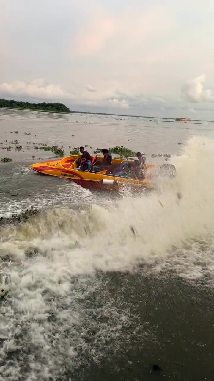 Our speedboat drifting on Vembanad Lake with a spray of water